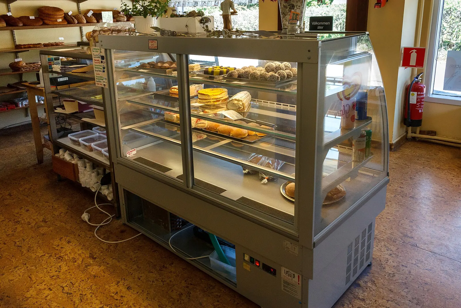 Glass display cases of cakes and pastries in a bakery. The photo was not taken in Woodstock.
