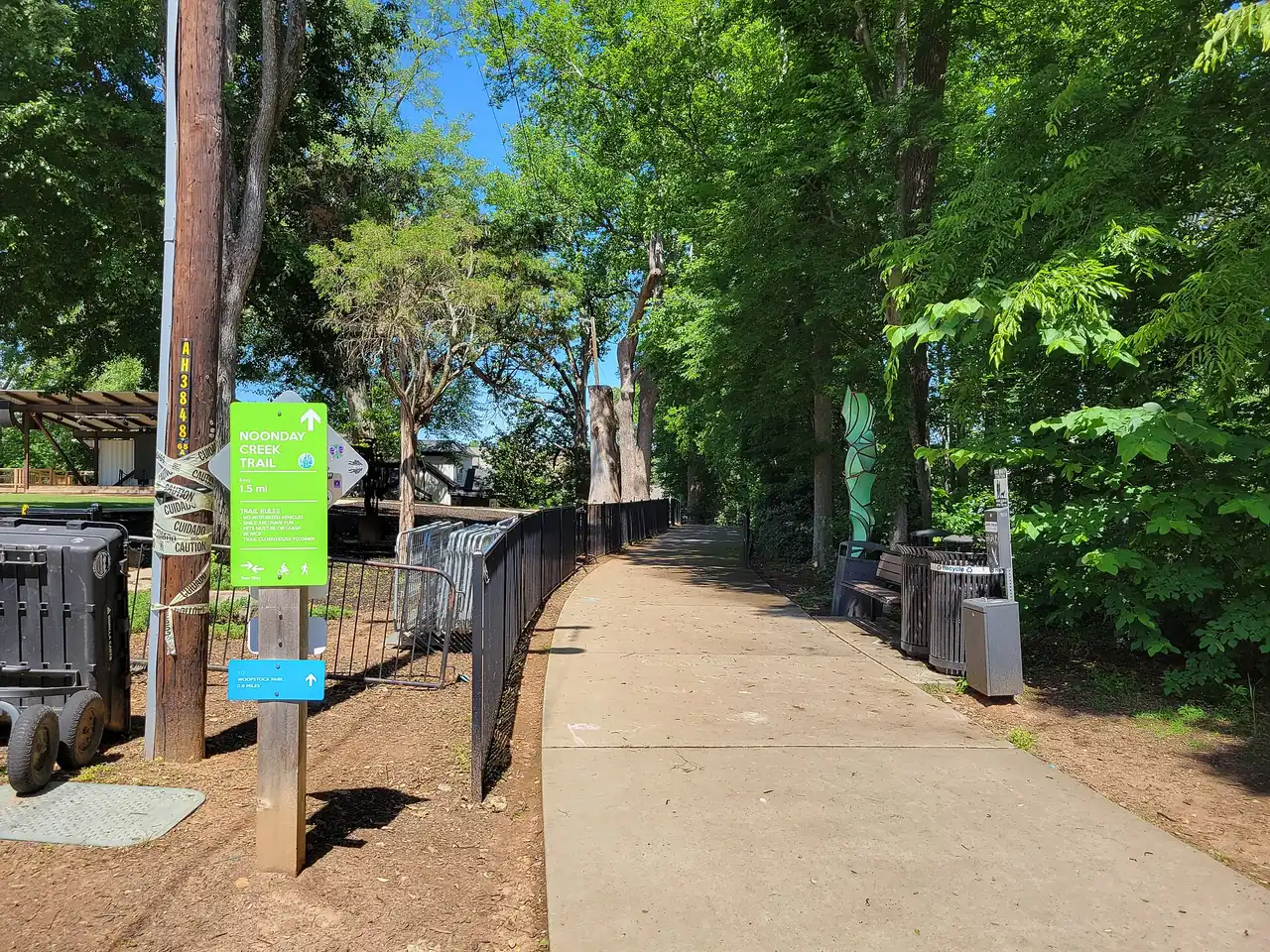 A Noonday Creek Trail sign beside the paved path near downtown Woodstock