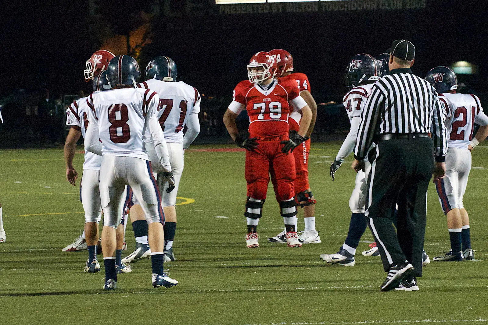 Woodstock High School players, in white, at a game against Milton High School