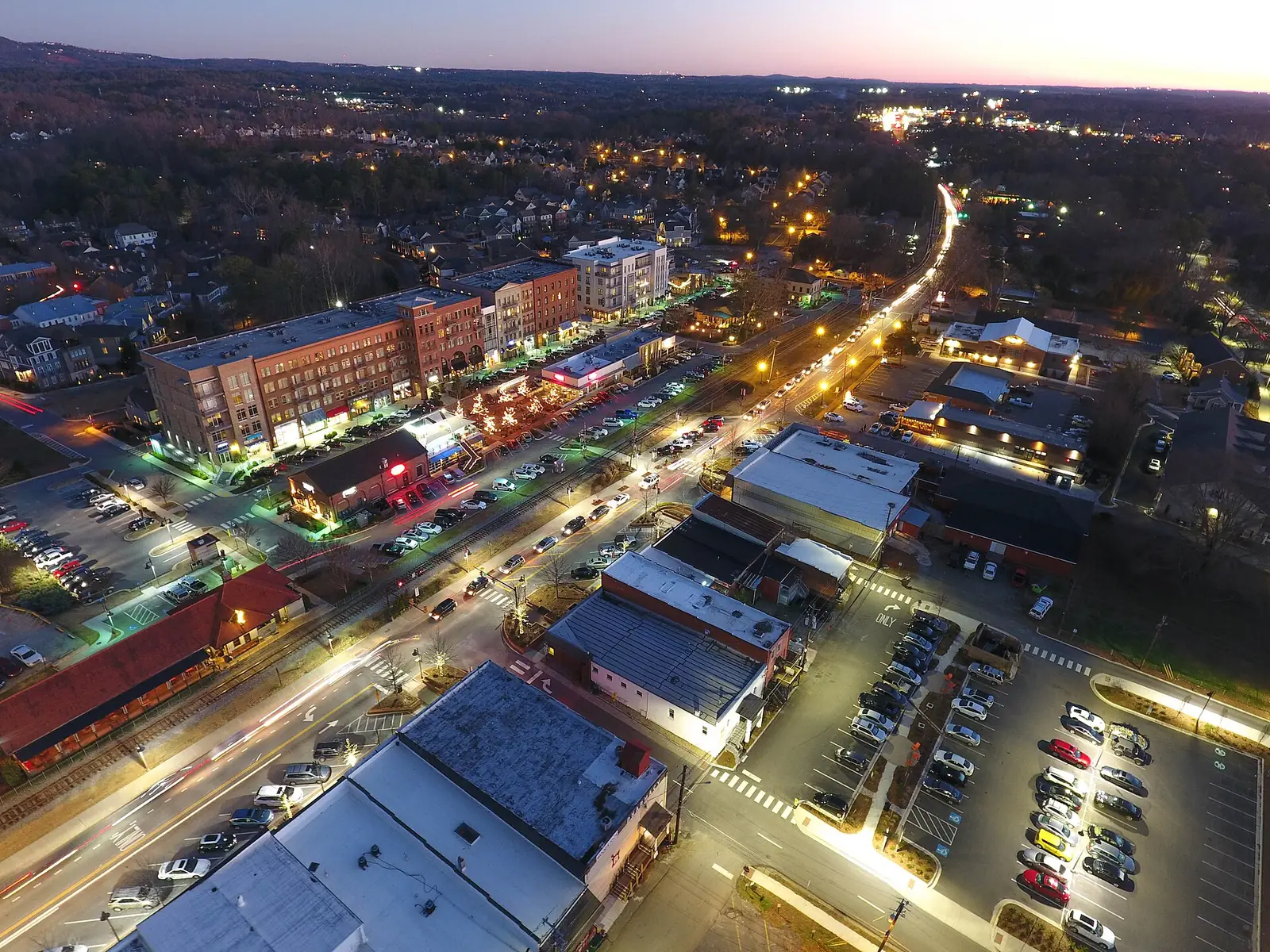 Downtown Woodstock from above at dusk, with its streets and buildings lit up