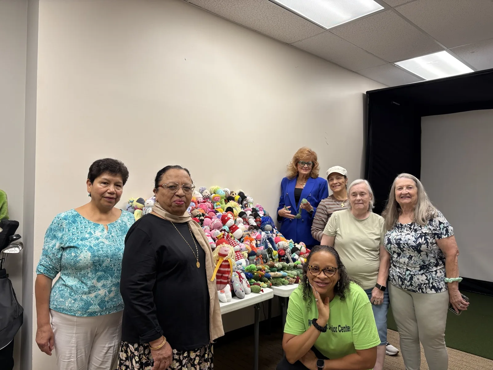 Members of the William G. Long Senior Center with the handmade dolls before they were donated to Cherokee County DFCS.