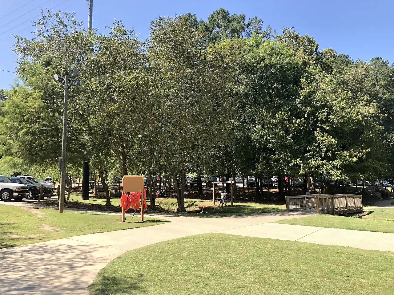 Picnic tables and paths under the trees at Olde Rope Mill Park in Woodstock