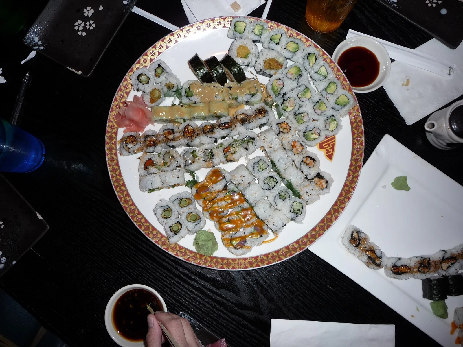 A platter of assorted sushi rolls with soy sauce. The photo was not taken at a Woodstock restaurant.