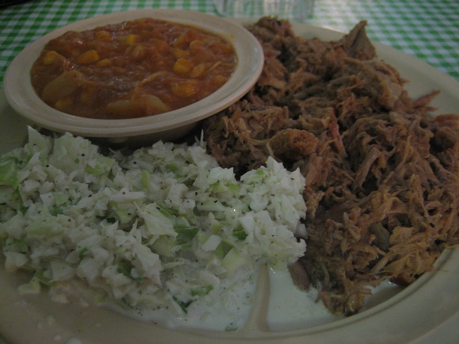 A plate of chopped pork barbecue with coleslaw and Brunswick stew. The photo was not taken at a Woodstock restaurant.